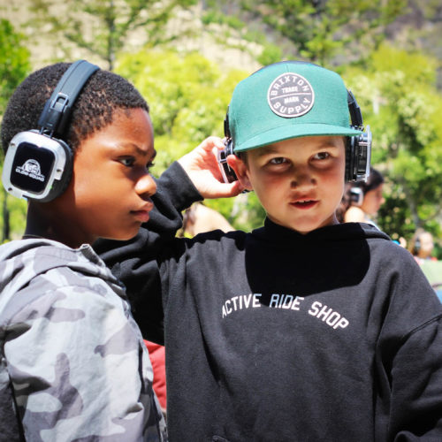 2 kids wearing glow squad headphones