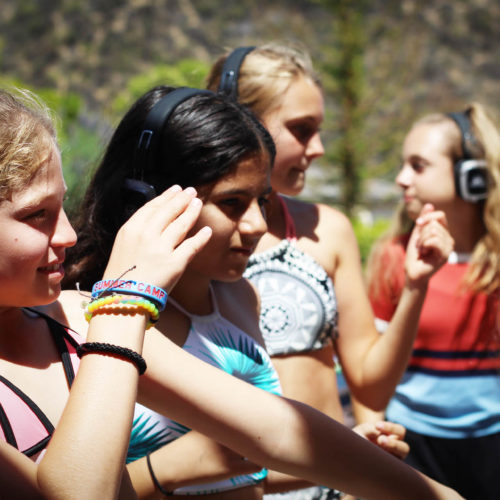 group of girls wearing glow squad headphones
